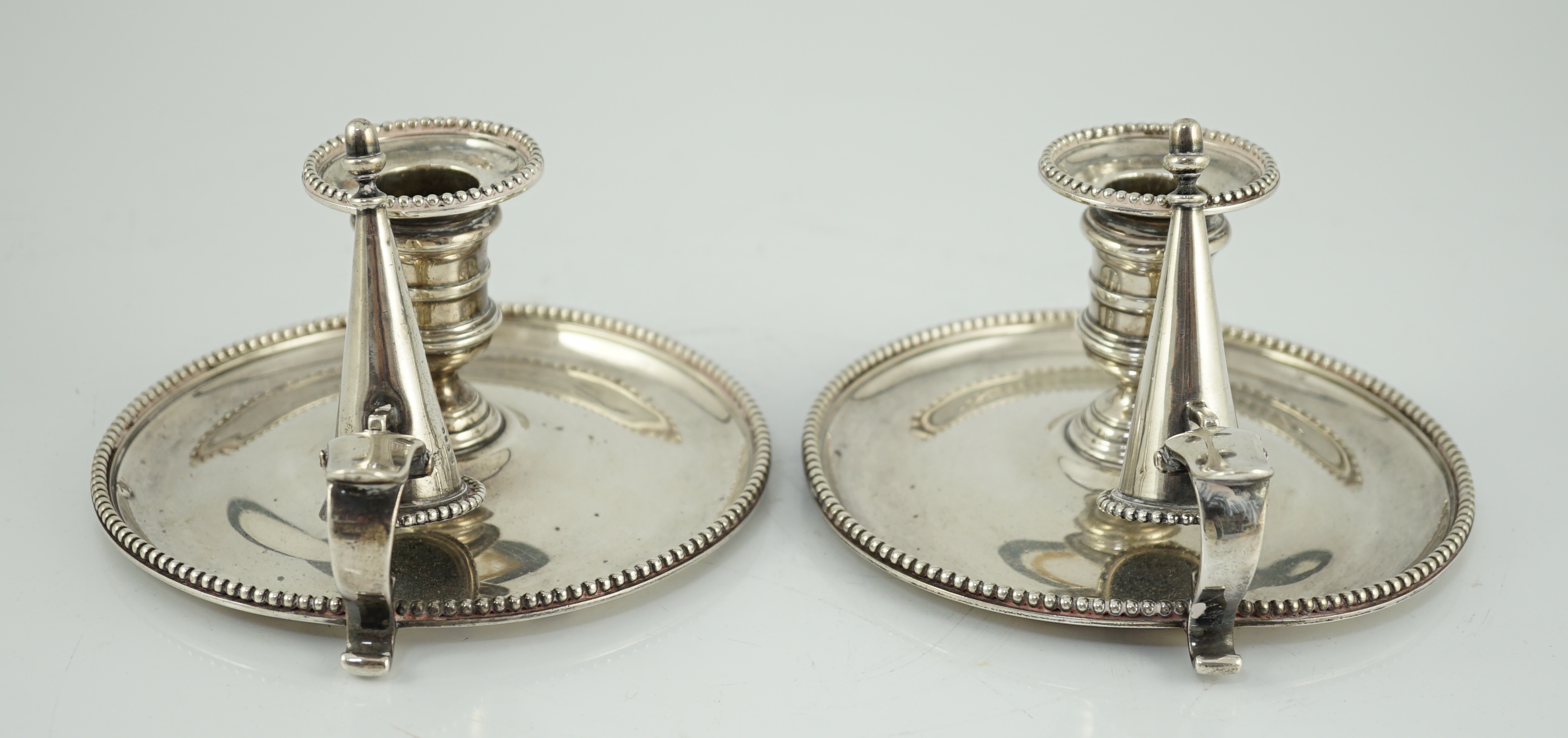 A pair of Victorian silver chambersticks and extinguishers, by Charles Thomas Fox and George Fox